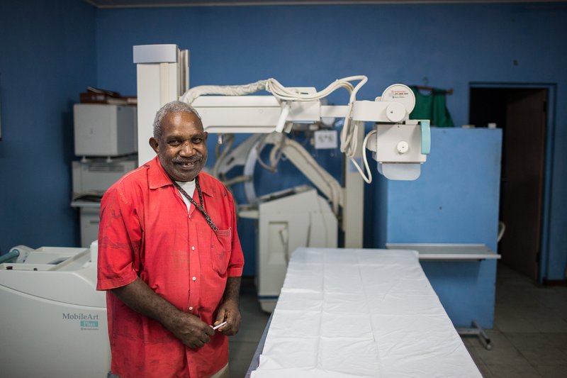 Radiologic technologist preparing for an X-ray examination at a hospital
